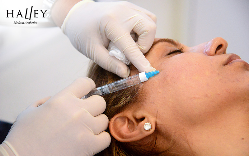Woman receiving a skin booster injection on her face.