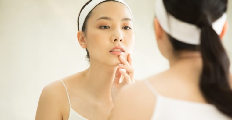 A woman looking in the mirror