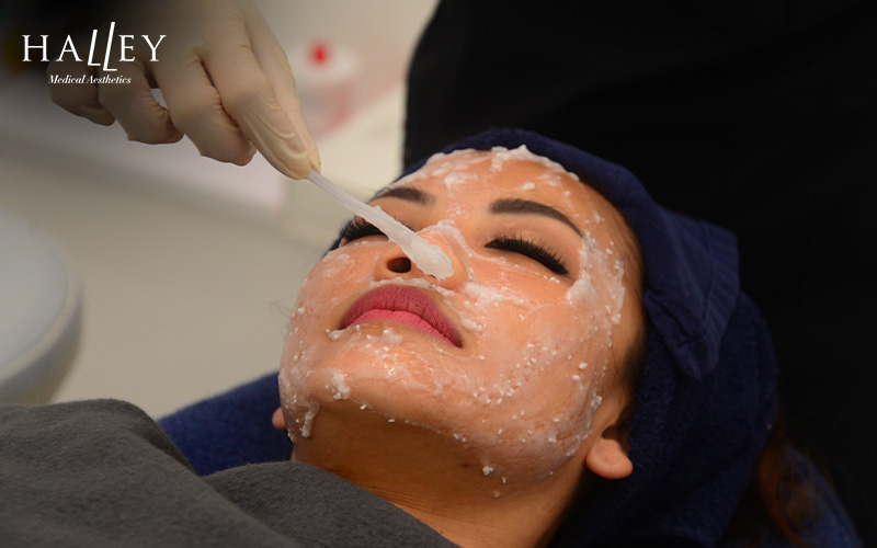 A client receiving a facial treatment for milia
