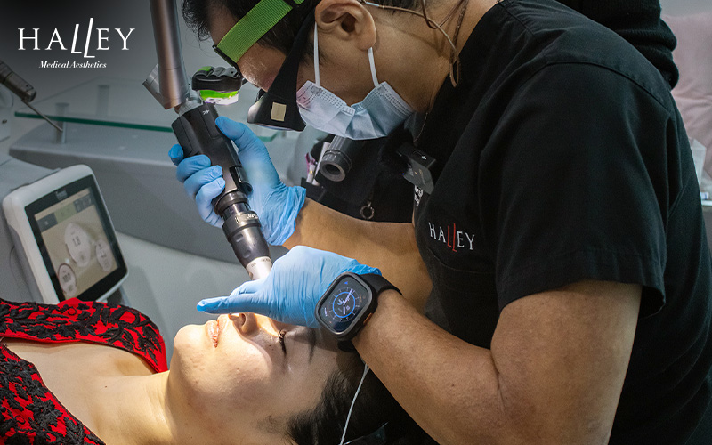 Doctor performing a laser facial on a patient at Halley Medical Aesthetics.